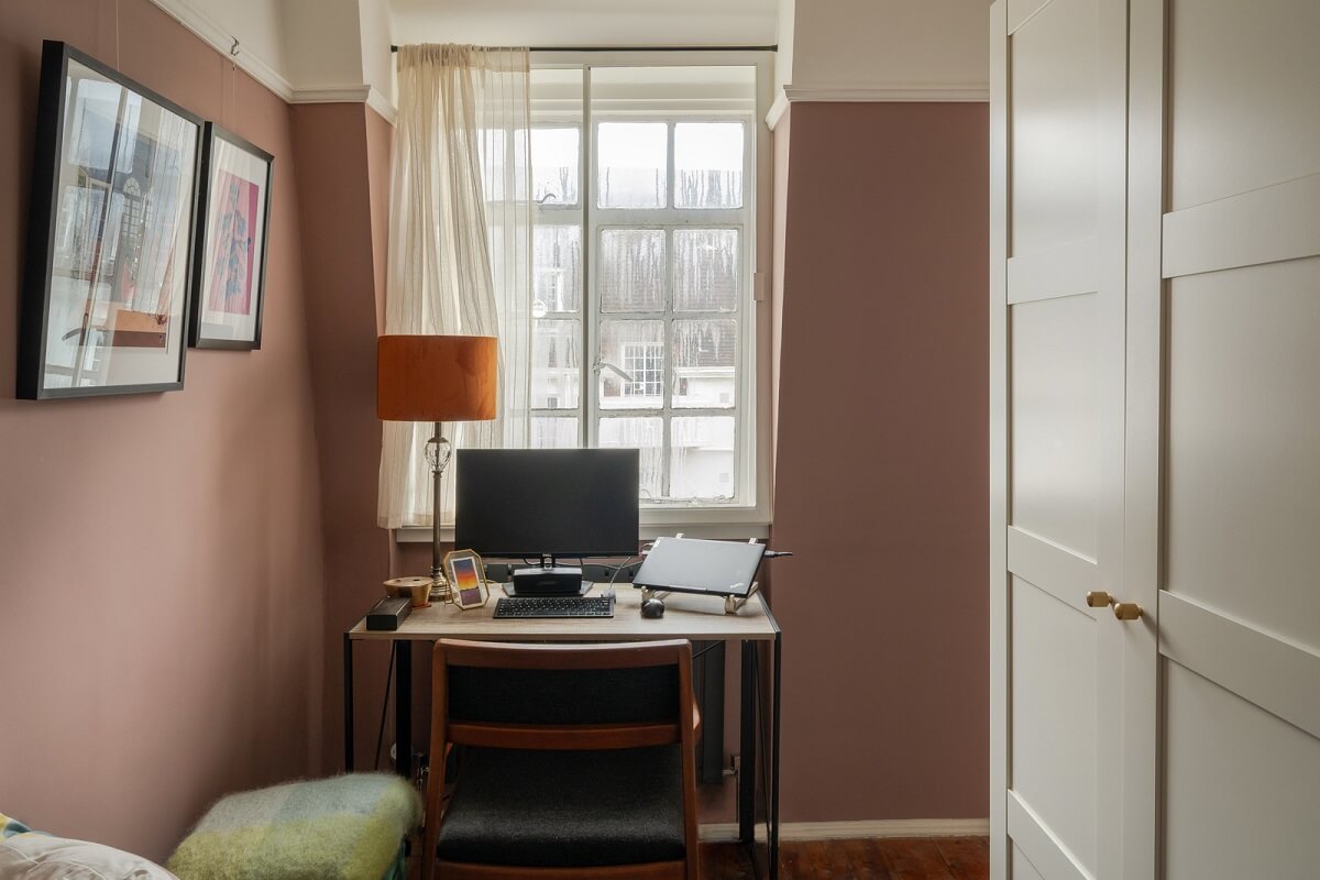 A Charming Top-Floor Apartment in an Art Deco Building 9 home office with dusty pink walls and wardrobes