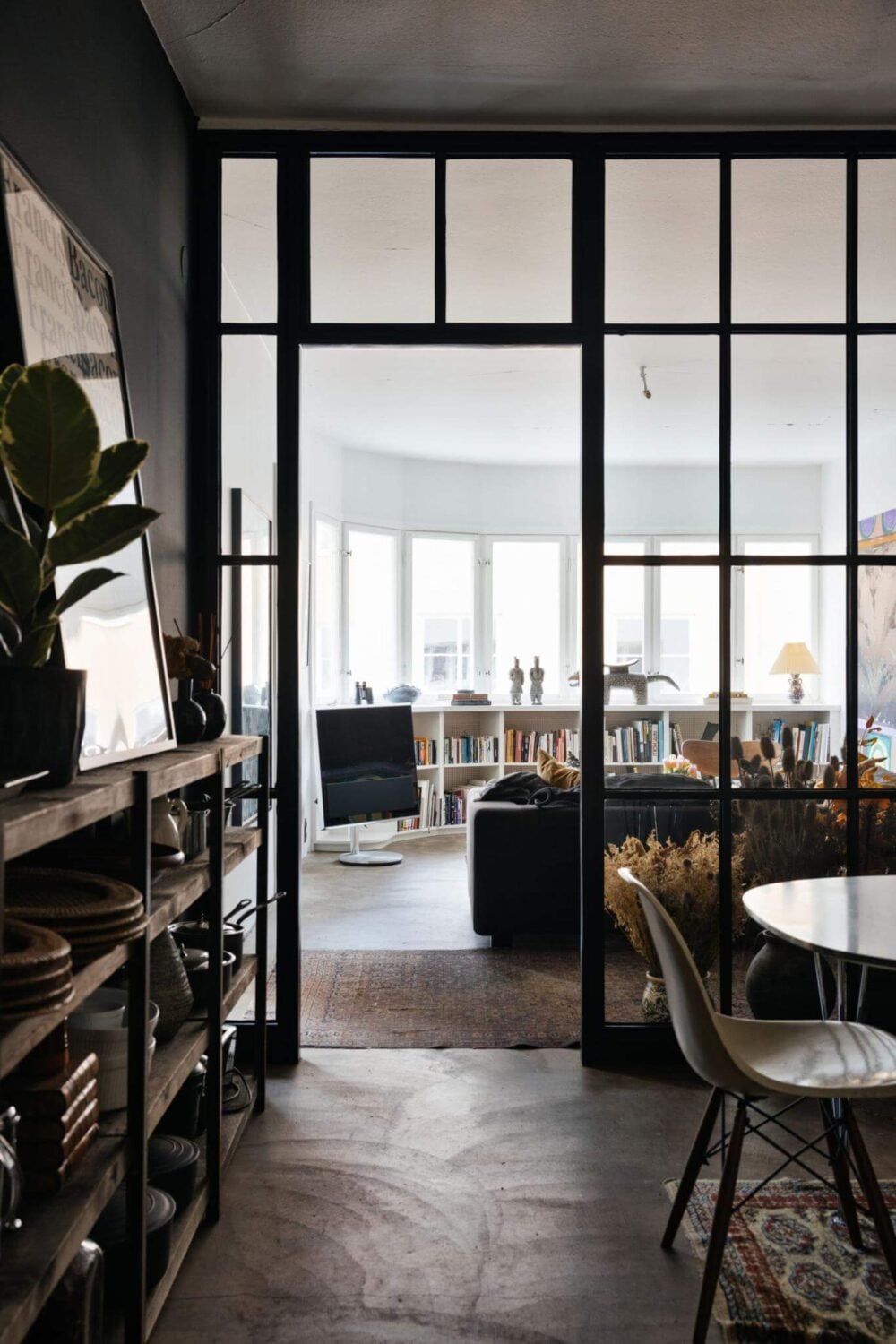 An Industrial Apartment with Black Walls 1 industrial glass wall in swedish apartment