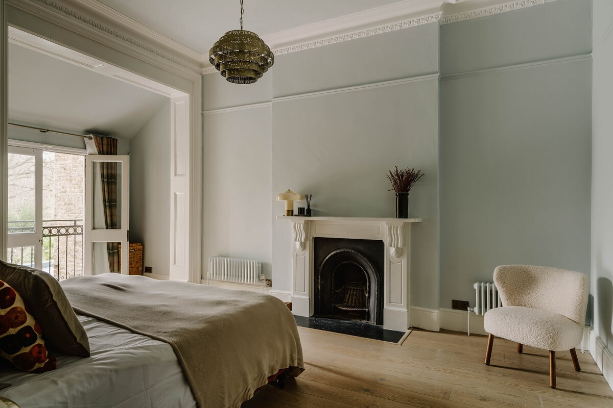 Colorful Walls in an English Victorian Townhouse 13 light blue bedroom with wooden floor and fireplace
