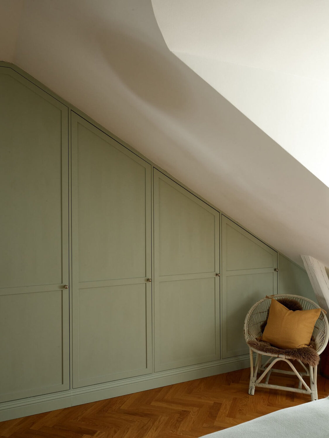 Green Tones in a Renovated Stockholm Duplex Apartment 15 light green built in wardrobes under slanted ceiling