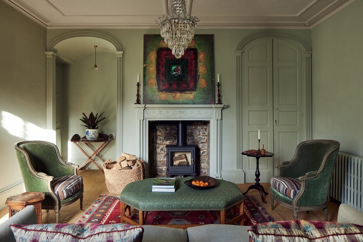 A Historic English Country House with Restored Interiors 9 light green living room fireplace built in cabinetss
