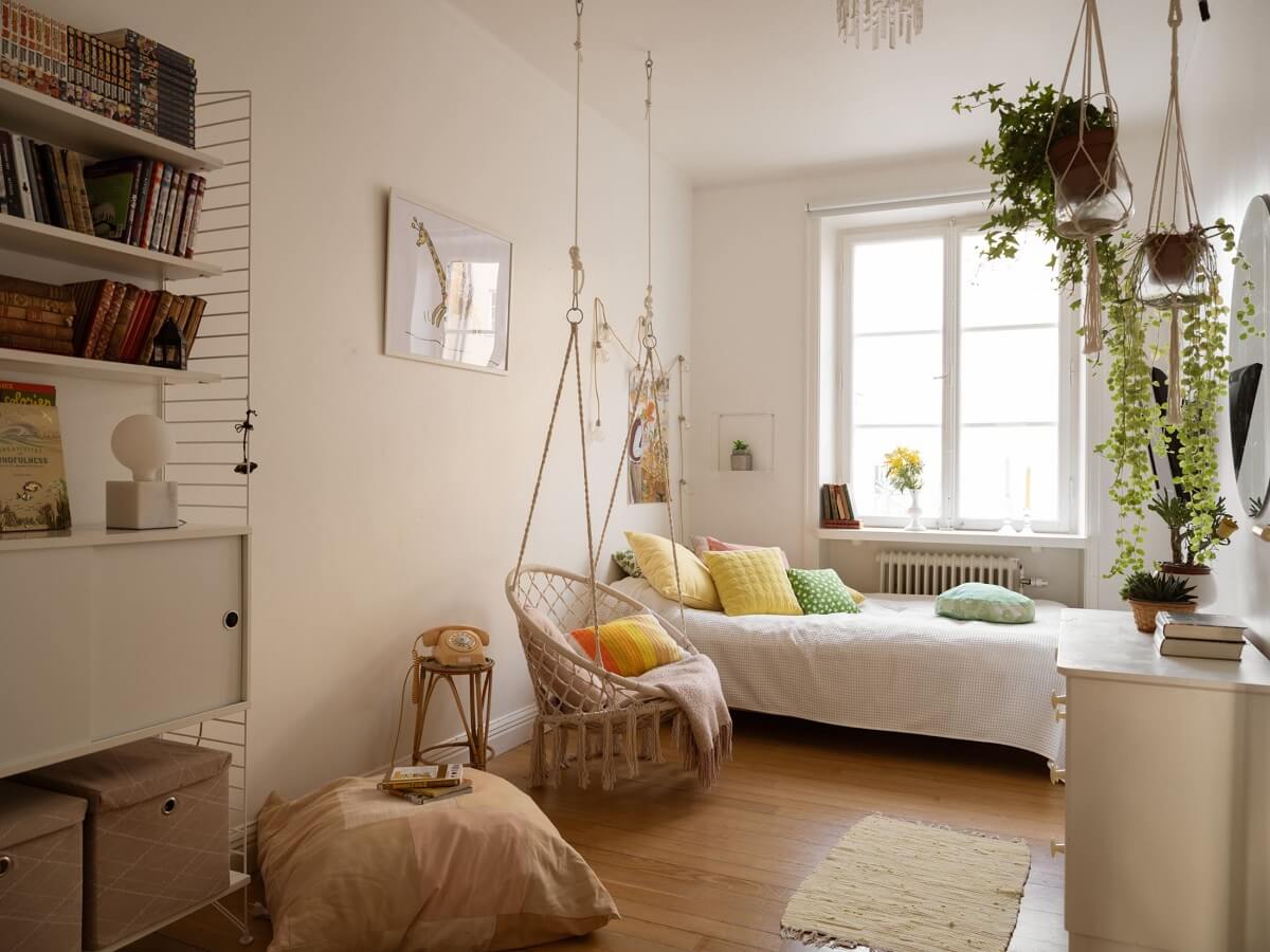 A Swedish Apartment with Light-Filled Rooms 11 light white bedroom with hanging chair