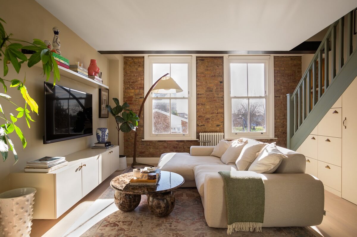 An Exposed Brick Wall in a London Duplex Apartment 1 living room with brick accent wall nordroom