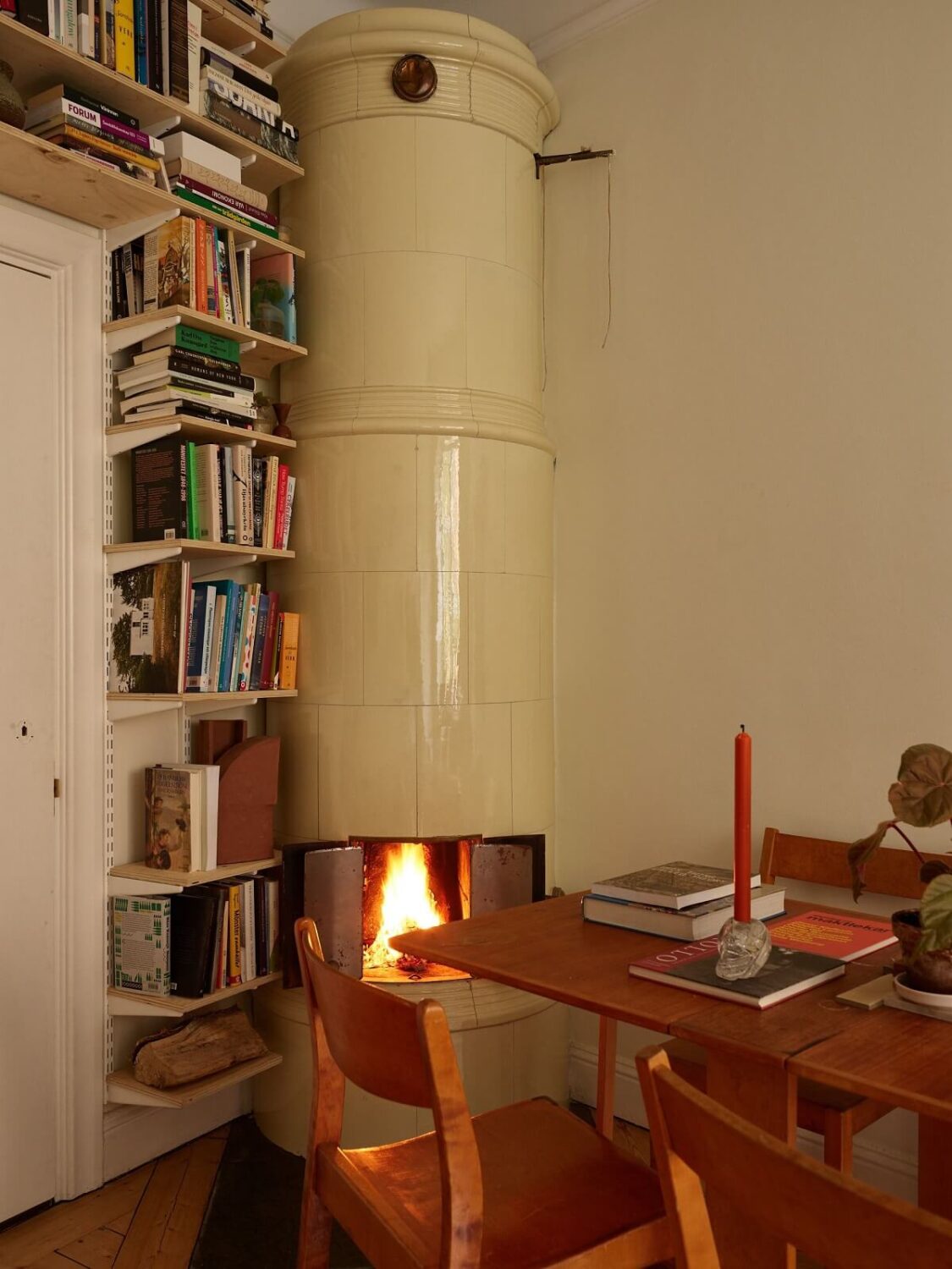 A Cozy Swedish Apartment Filled with Charm 7 living room with fireplace and bookshelves