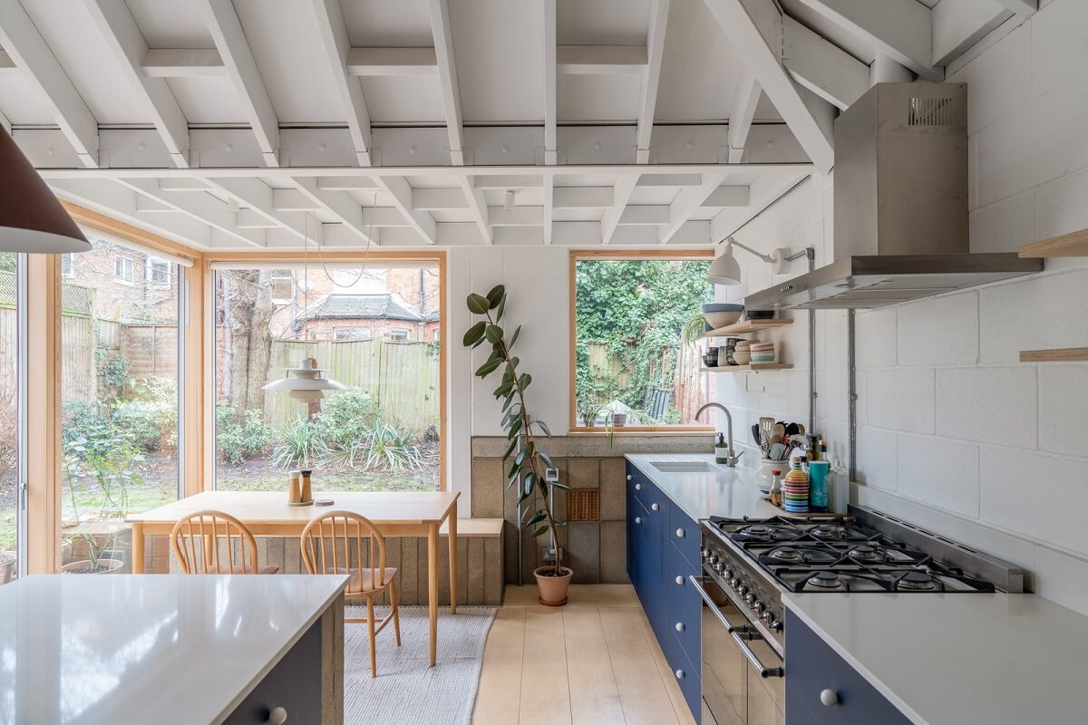 An Award-Winning Apartment with a Modern Extension 6 modern kitchen extension with blue cabinets and dining space nordroom