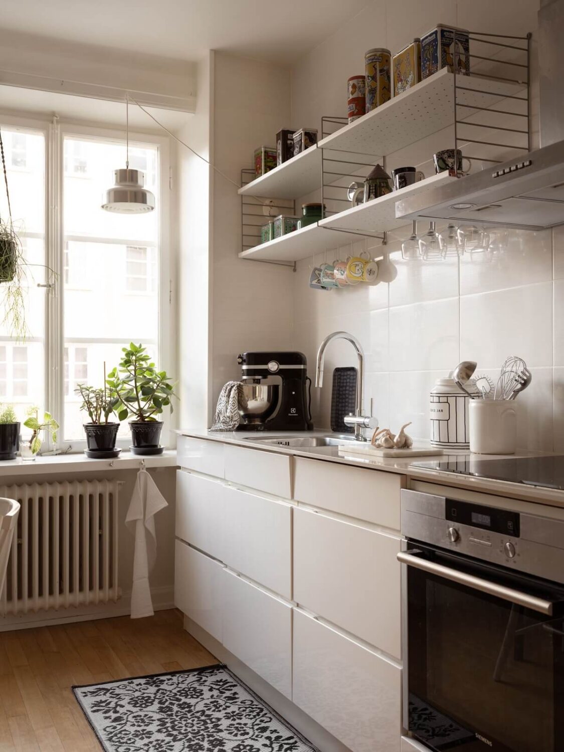 A Swedish Apartment with Light-Filled Rooms 8 modern white kitchen with shelves