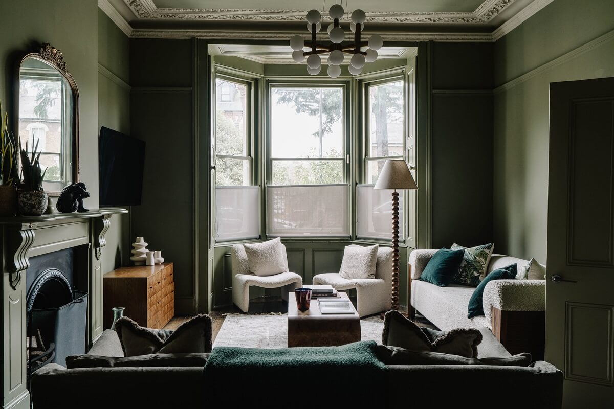 Colorful Walls in an English Victorian Townhouse 1 moody dark green living room with bay window and period features nordroom