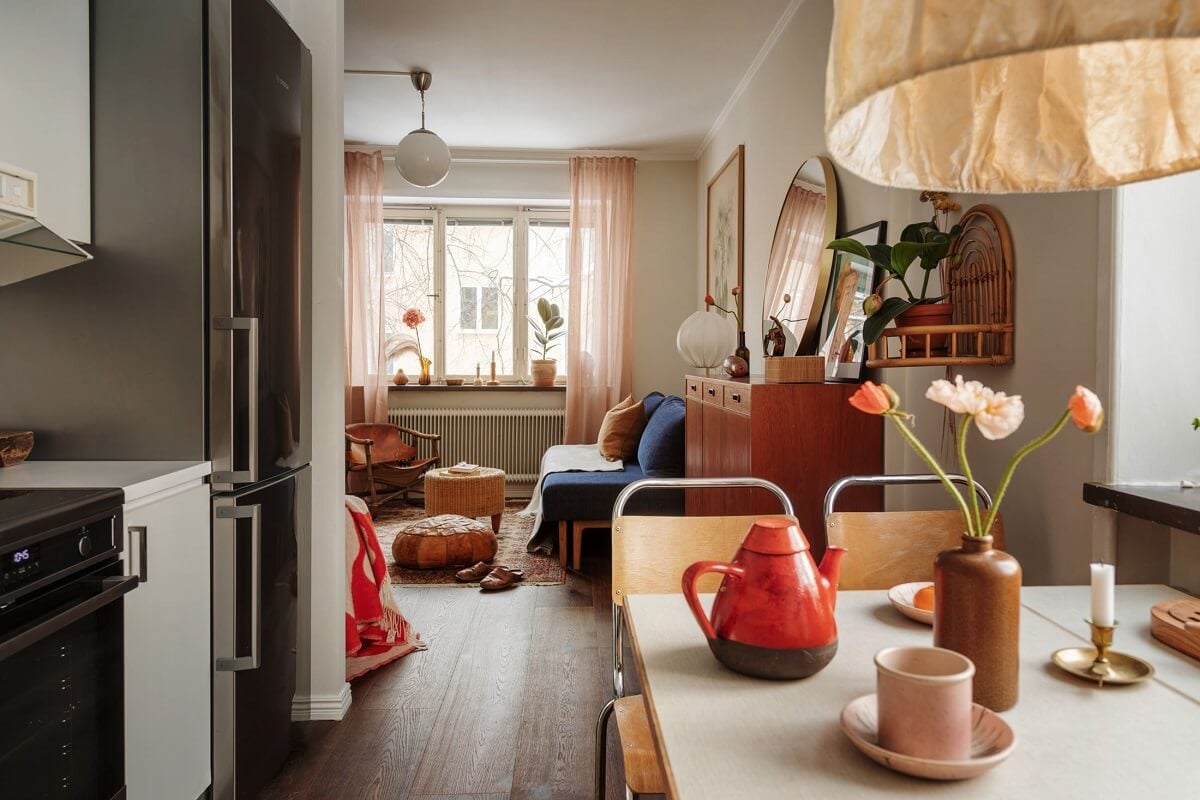 A Small Swedish Apartment with Warm Color Accents 14 open plan kitchen living room