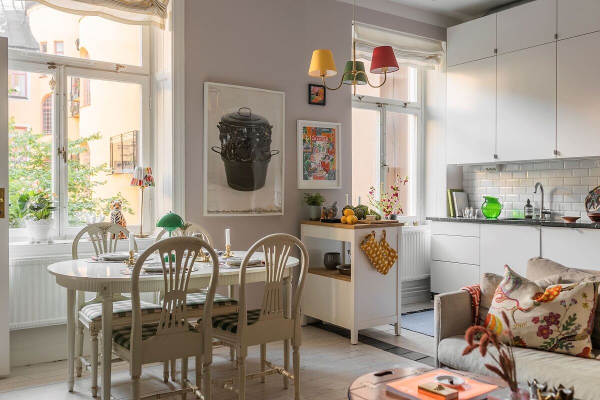 A Small Split-Level Apartment in Stockholm 6 open plan living room kitchen with white cabinets