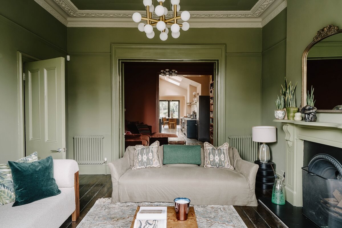 Colorful Walls in an English Victorian Townhouse 2 open plan sitting room green walls fireplace nordroom