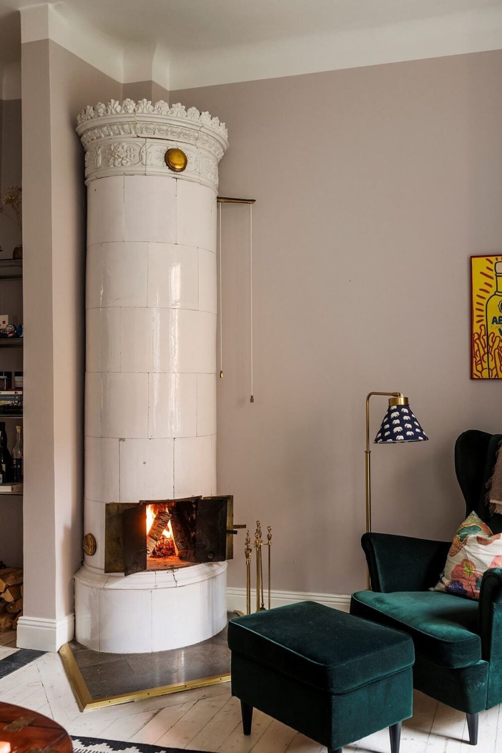 A Small Split-Level Apartment in Stockholm 4 round fireplace and green velvet ikea chair