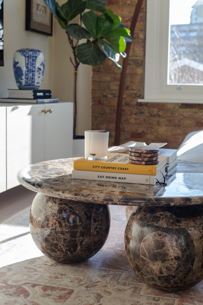 An Exposed Brick Wall in a London Duplex Apartment 5 round marble coffee table