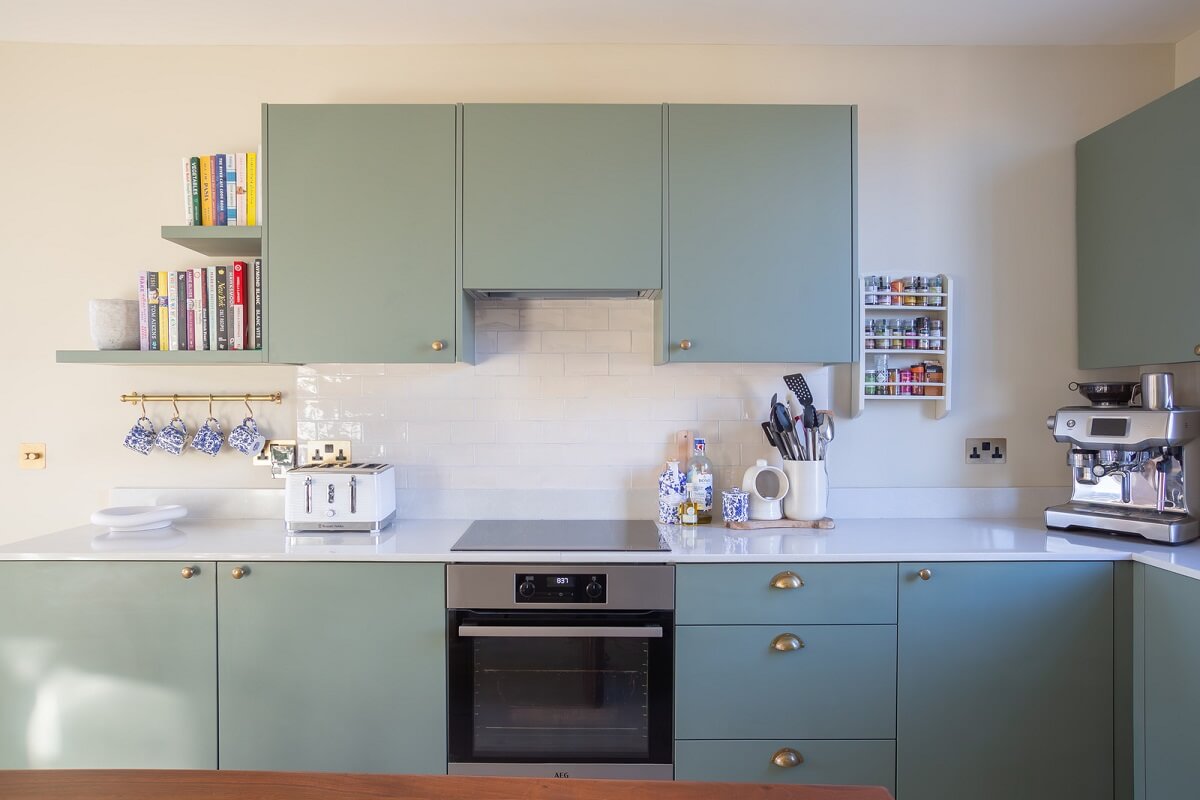 An Exposed Brick Wall in a London Duplex Apartment 10 sage green kitchen cabinets