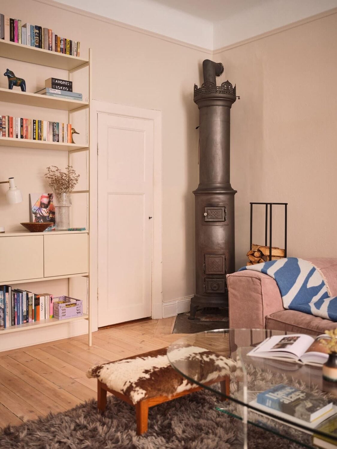 Serene Light Painted Spaces in a Swedish Apartment 4 scandi-living-room-woodburner-bookshelves-nordroom