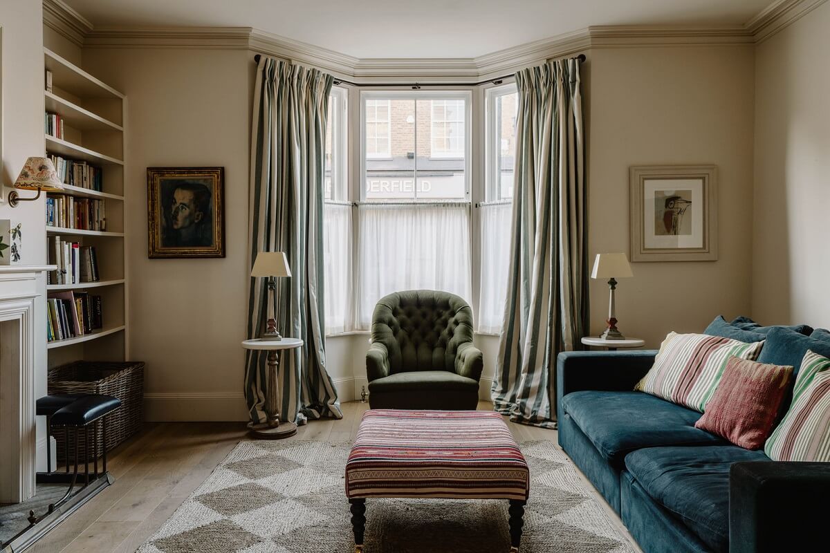 A Restored and Extended London Townhouse 1 serene living room with shelves and blue sofa