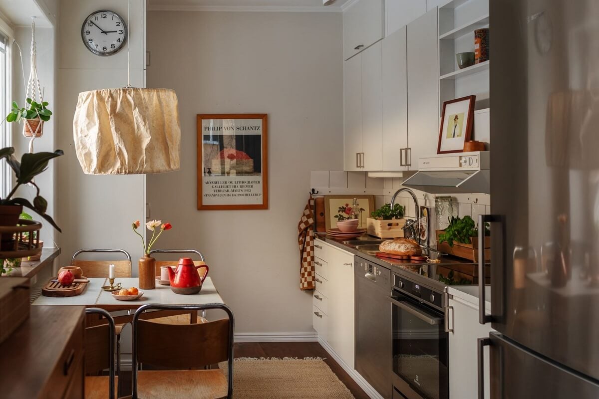 A Small Swedish Apartment with Warm Color Accents 10 small apartment kitchen with white cabinets
