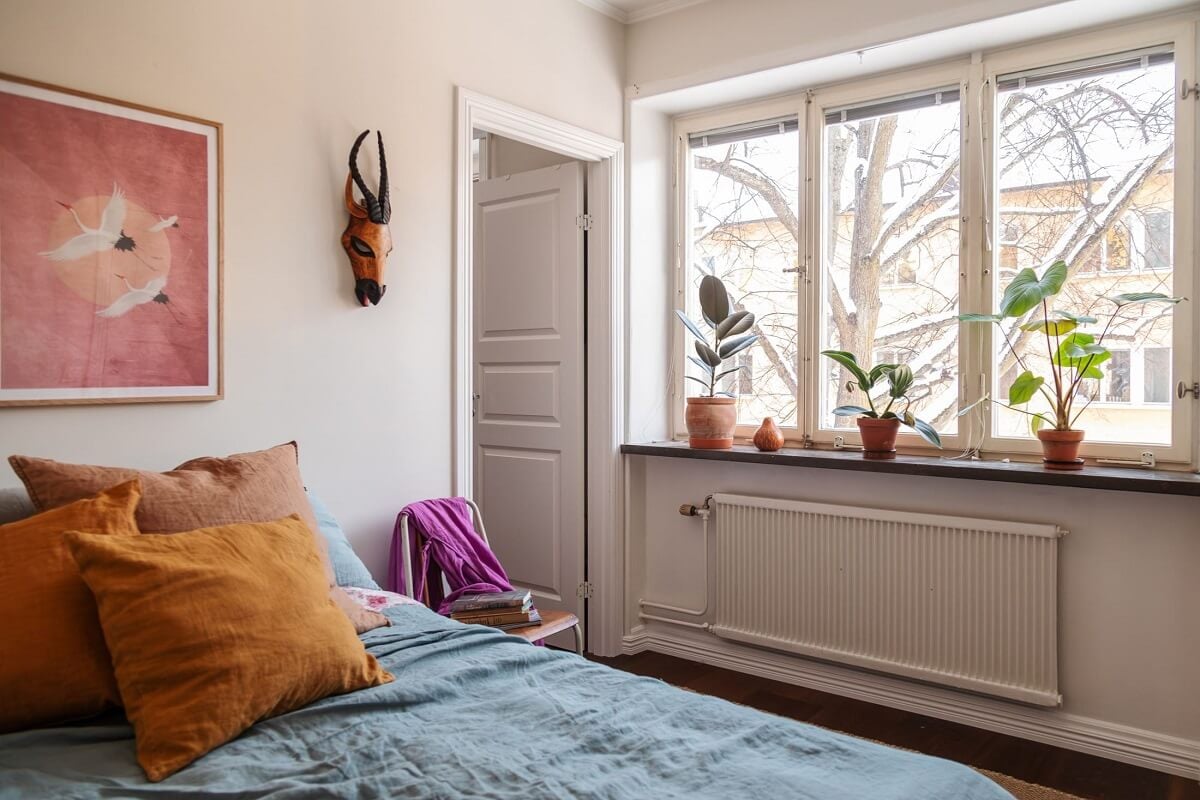 A Small Swedish Apartment with Warm Color Accents 16 small bedroom with blue and yellow color accents