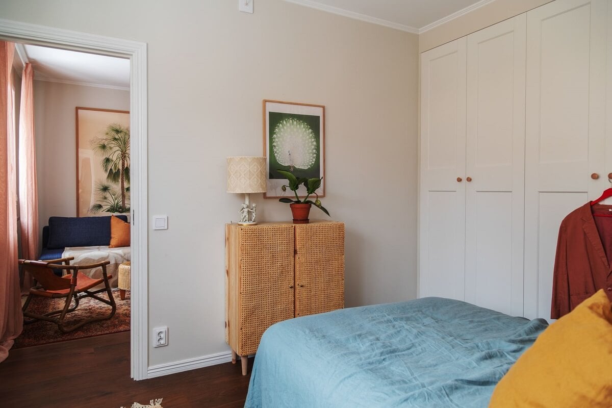 A Small Swedish Apartment with Warm Color Accents 15 small bedroom with blue bedding and built in wardrobes