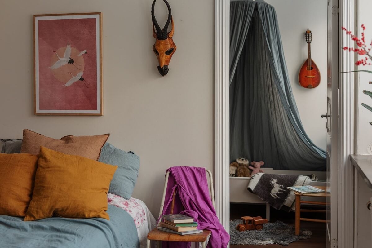 A Small Swedish Apartment with Warm Color Accents 17 small bedroom with ochre yellow and blue bedding nordroom