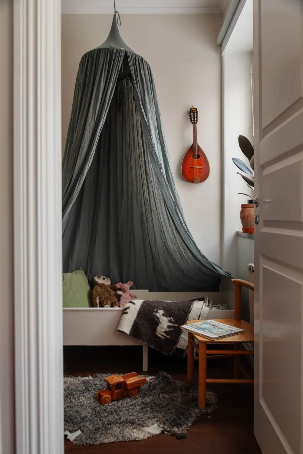 A Small Swedish Apartment with Warm Color Accents 18 small kids bedroom with gray canopy