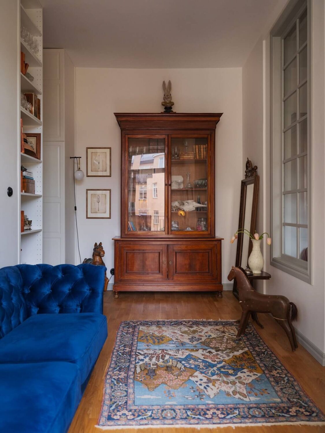 A Tiny Apartment with Antique Furniture 5 small living room with cobalt blue sofa and antique cabinet nordroom