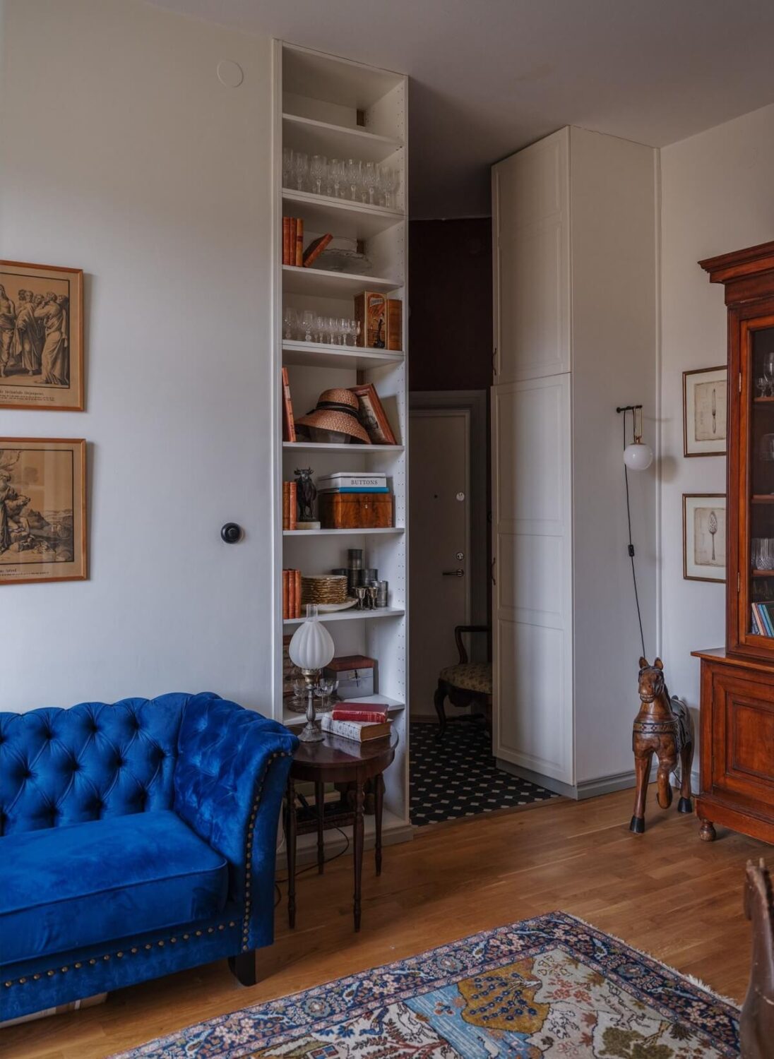 A Tiny Apartment with Antique Furniture 4 small living room with floor to ceiling bookshelves and blue sofa