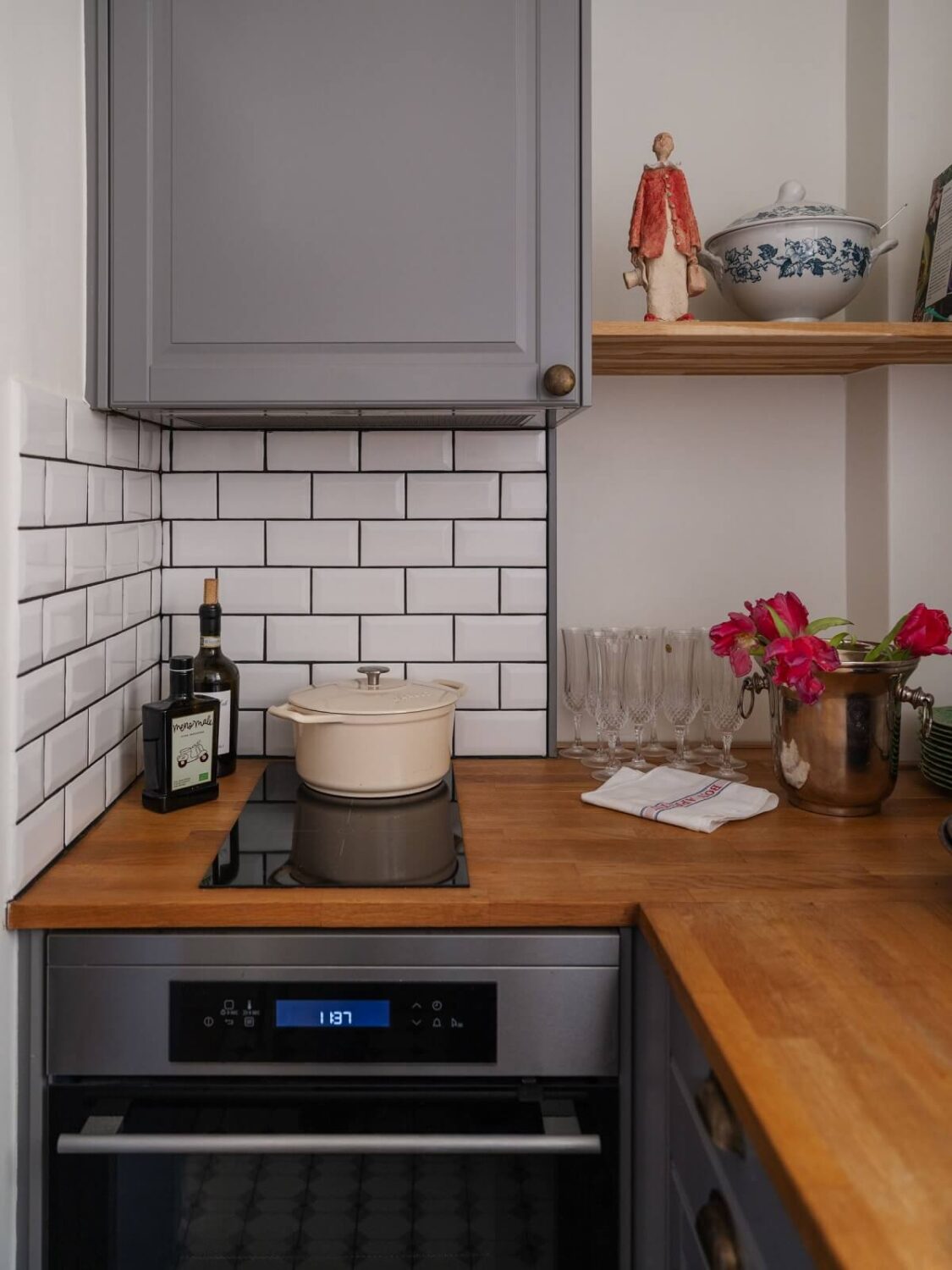 A Tiny Apartment with Antique Furniture 13 tiny gray kitchen with subway tiles and wooden worktop nordroom