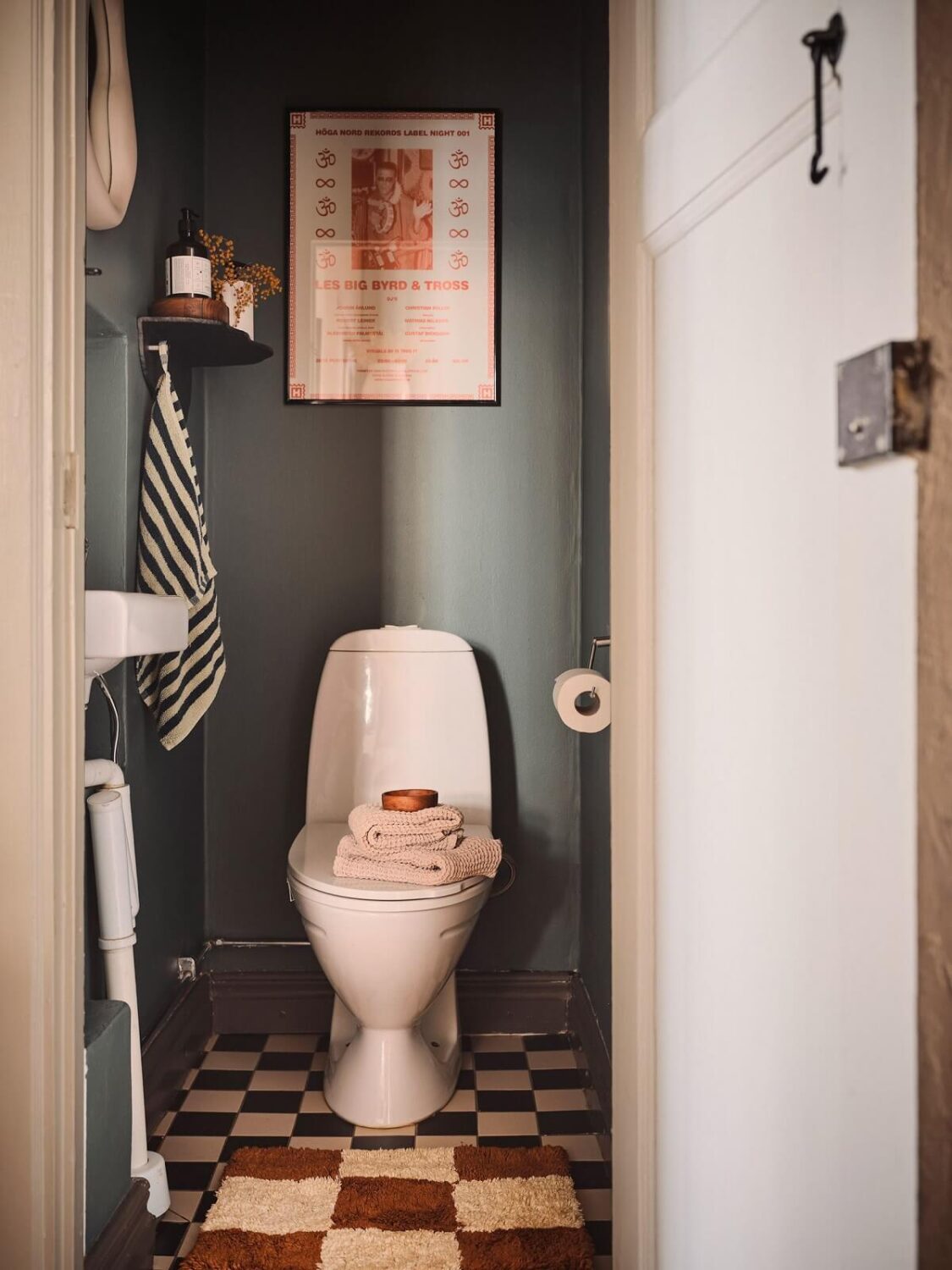 Serene Light Painted Spaces in a Swedish Apartment 16 toilet-dark-gray-walls