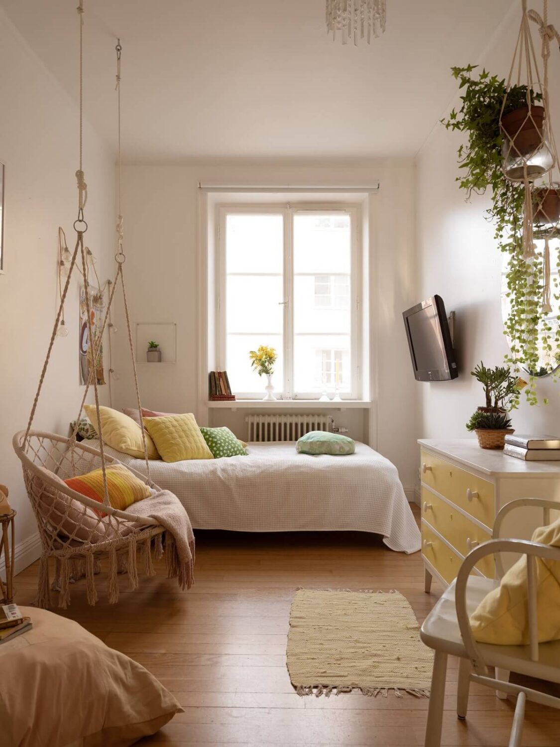A Swedish Apartment with Light-Filled Rooms 10 white bedroom with hanging chair