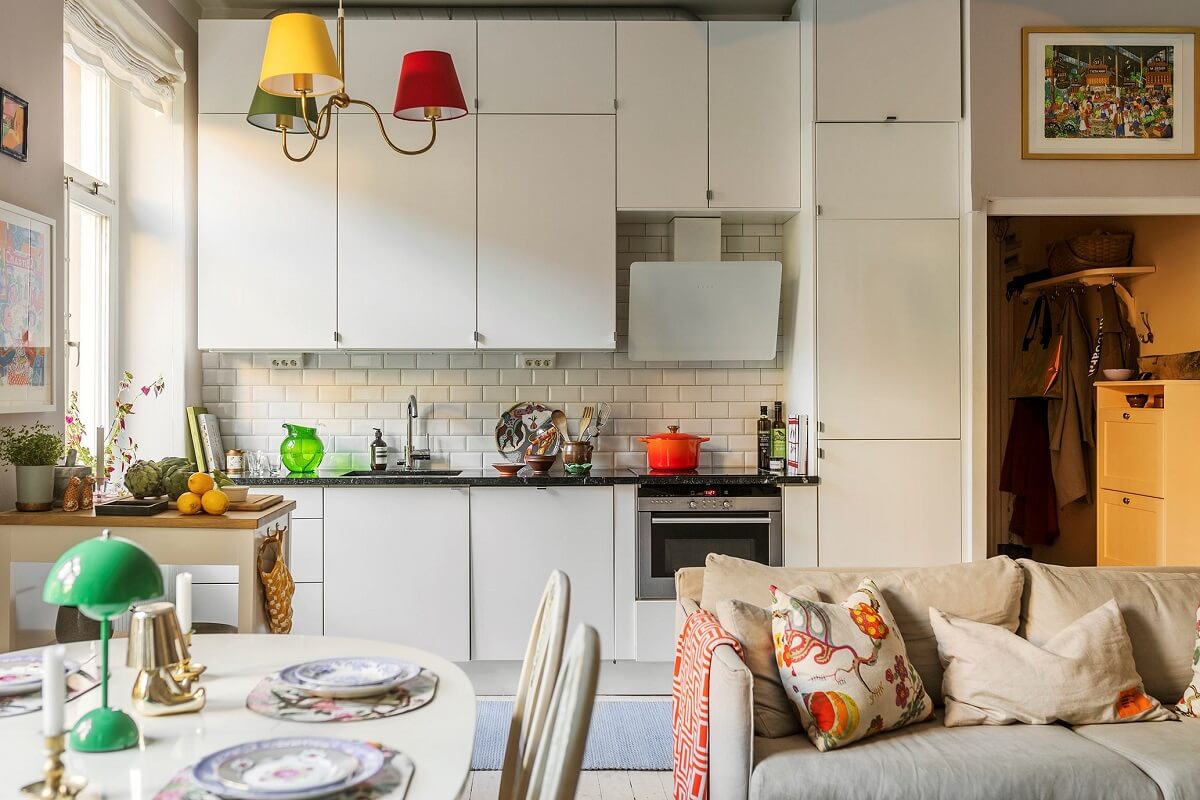 A Small Split-Level Apartment in Stockholm 7 white kitchen open plan living space