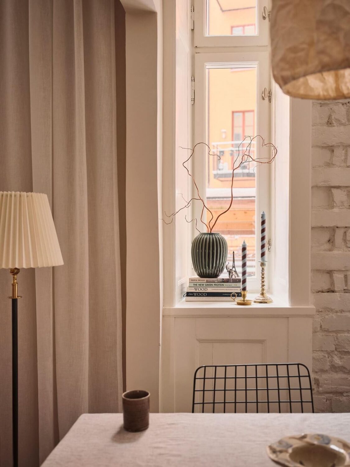 Serene Light Painted Spaces in a Swedish Apartment 11 white-painted-brick-wall-dining-table-nordroom