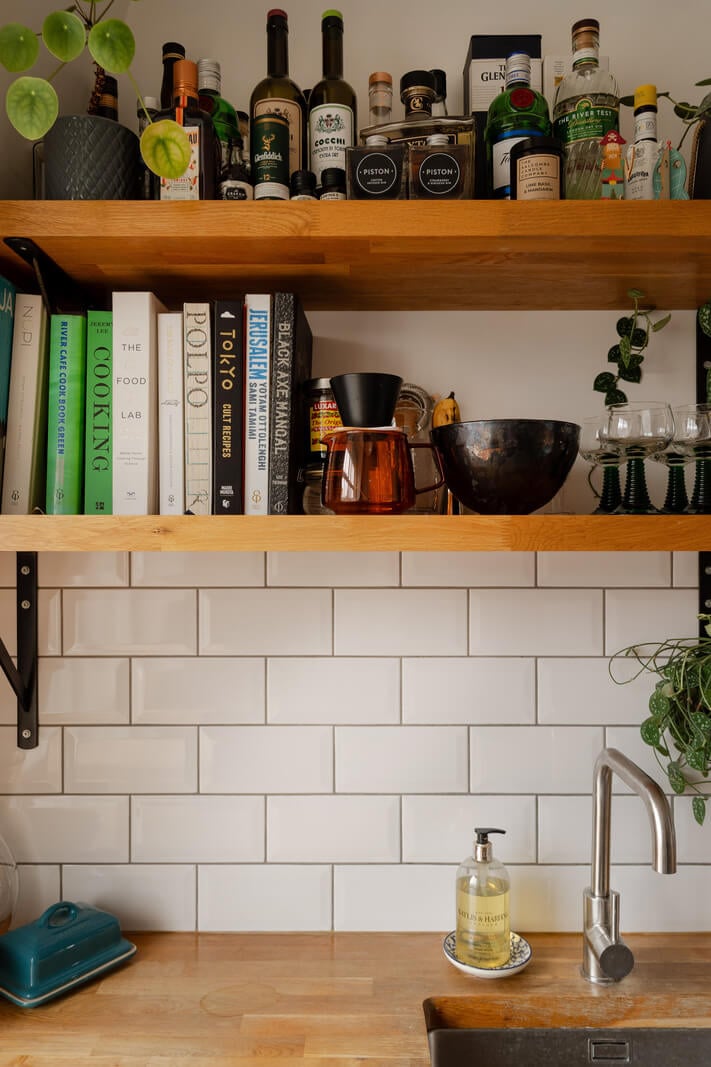 A Charming Top-Floor Apartment in an Art Deco Building 6 wooden kitchen shelves and white subway tiles