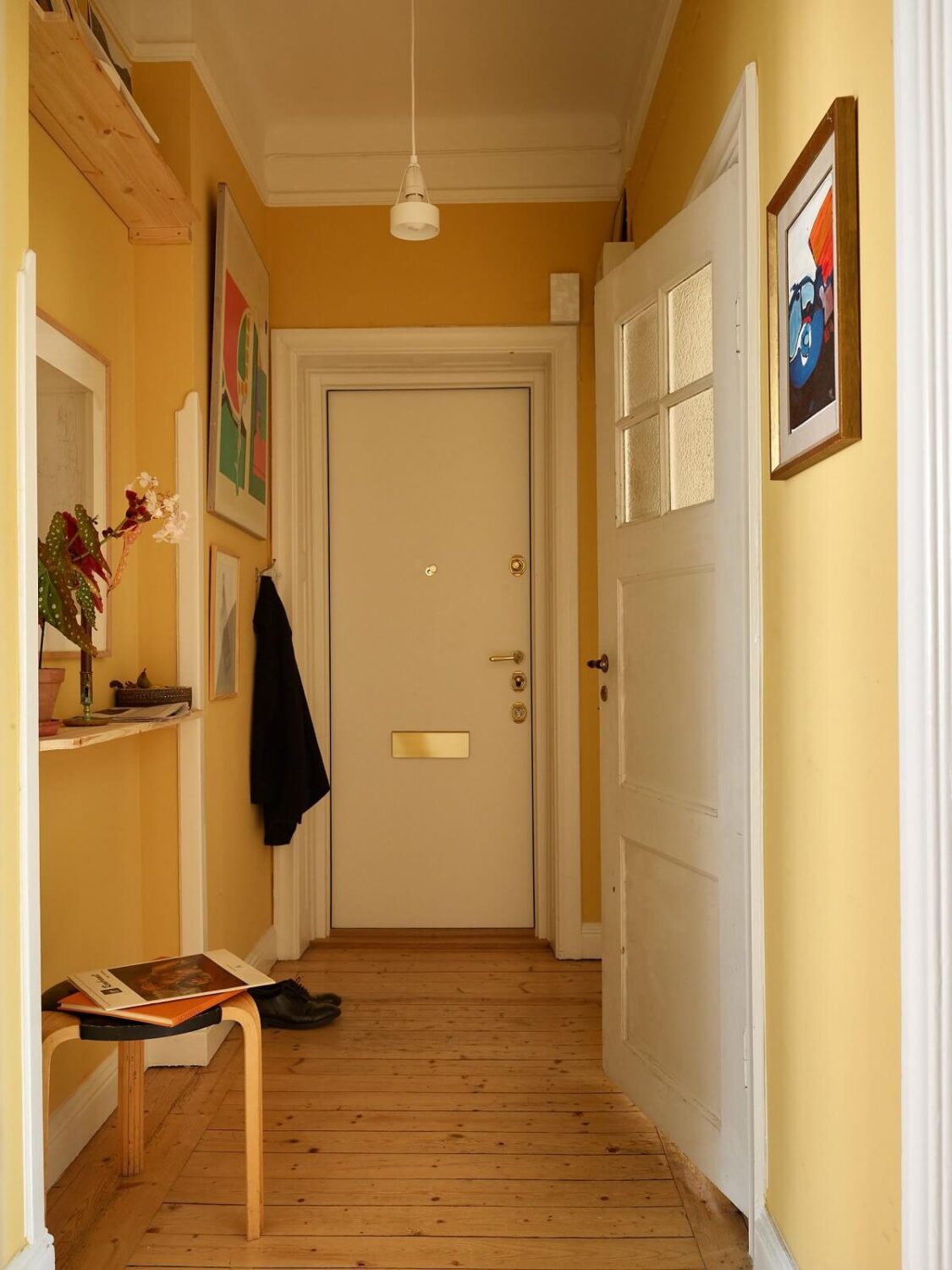 A Cozy Swedish Apartment Filled with Charm 15 yellow hallway