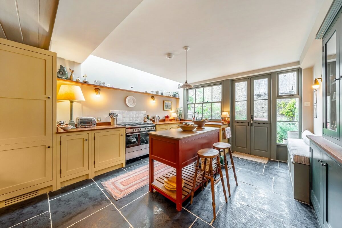 A Colorful Historic Family Home in London 6 yellow kitchen cabinets with red island