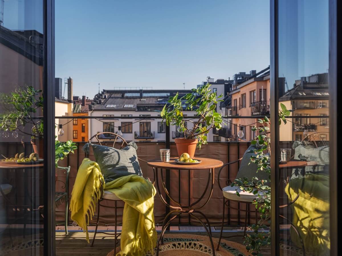 A Classic Swedish Apartment Decorated in Green and Pink Tones 4 balcony with view of stockholm houses