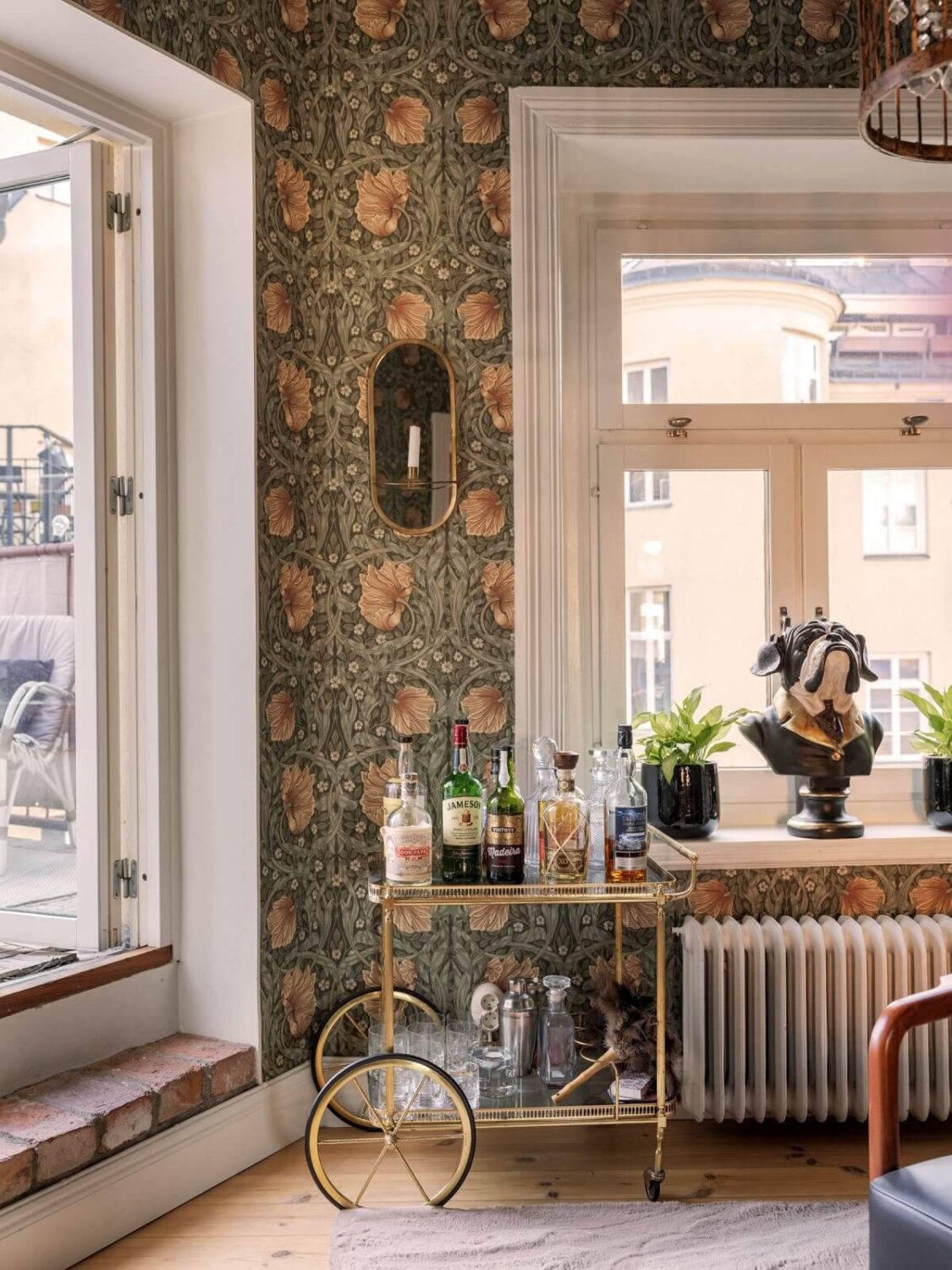 A Classic Swedish Apartment Decorated in Green and Pink Tones 13 bar cart and william morris wallpaper