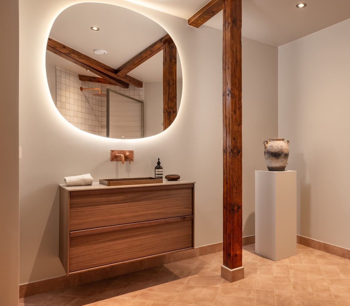 An Attic Apartment in Oslo with Exposed Wooden Beams 12 bathroom with large and lighted round mirror
