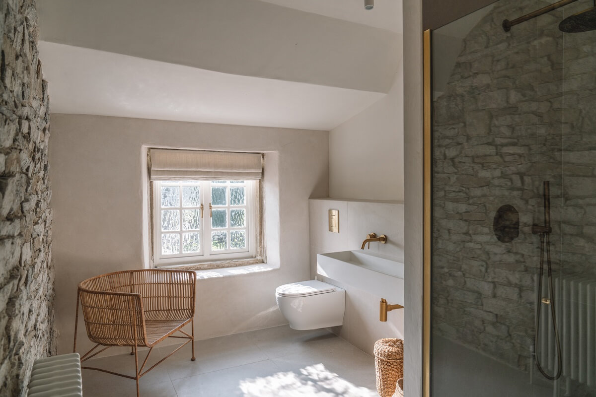 Contemporary Interiors in a Historic English House 17 bathroom with stone wall