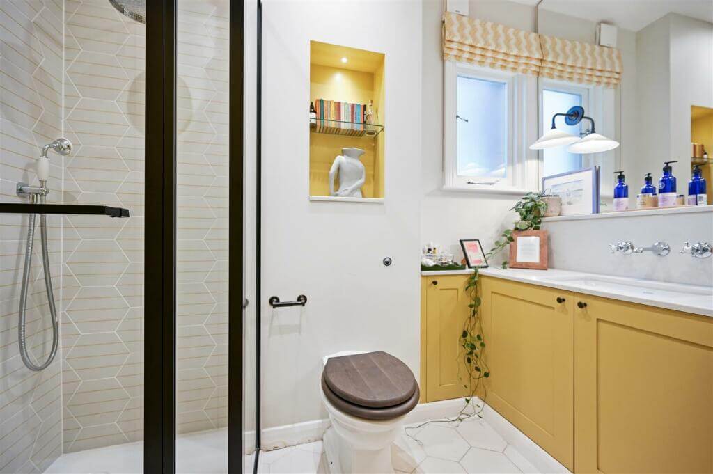 A London Family Home with Blue Color Accents 13 bathroom with yellow vanity cabinets
