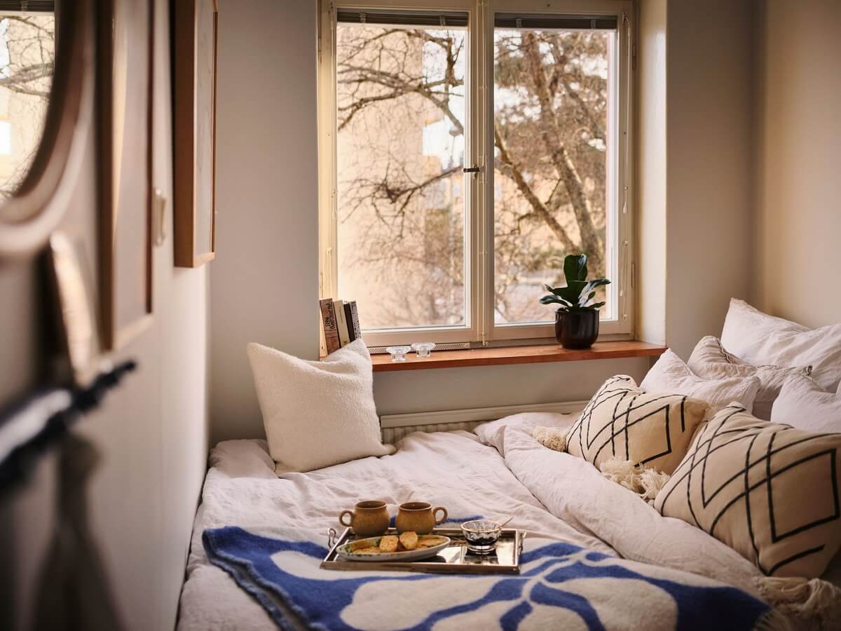 A Small Midcentury Apartment in Stockholm 11 bed in front of the window