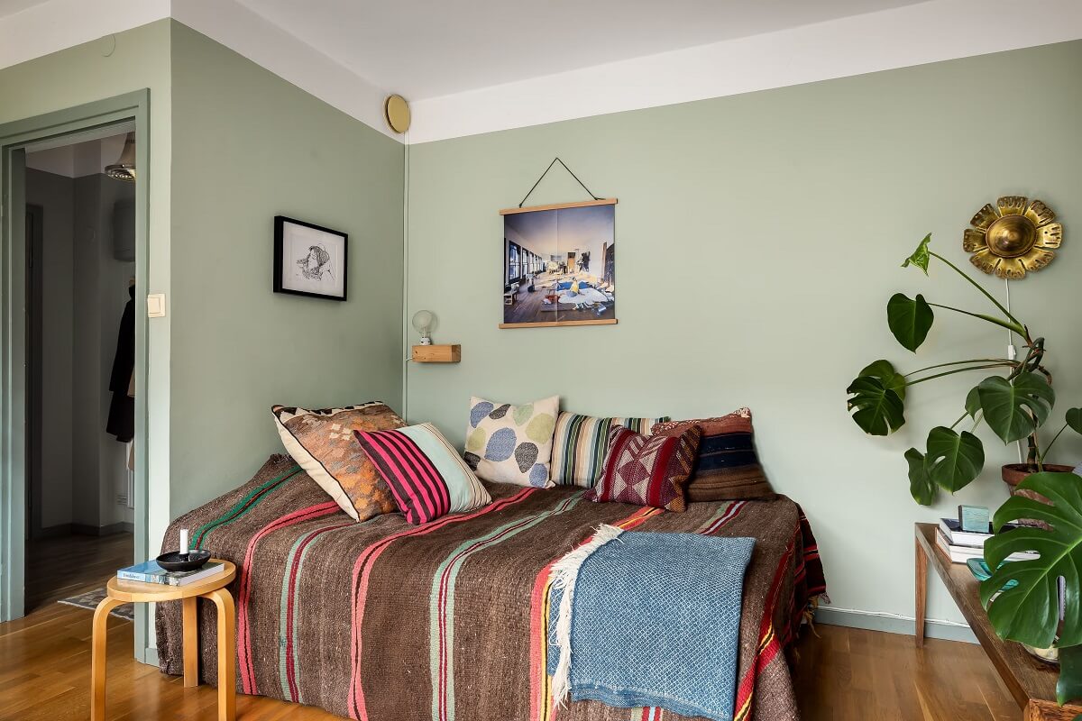 A Cozy Studio Apartment with a Yellow Kitchen 7 bed nook with earth colored bedding