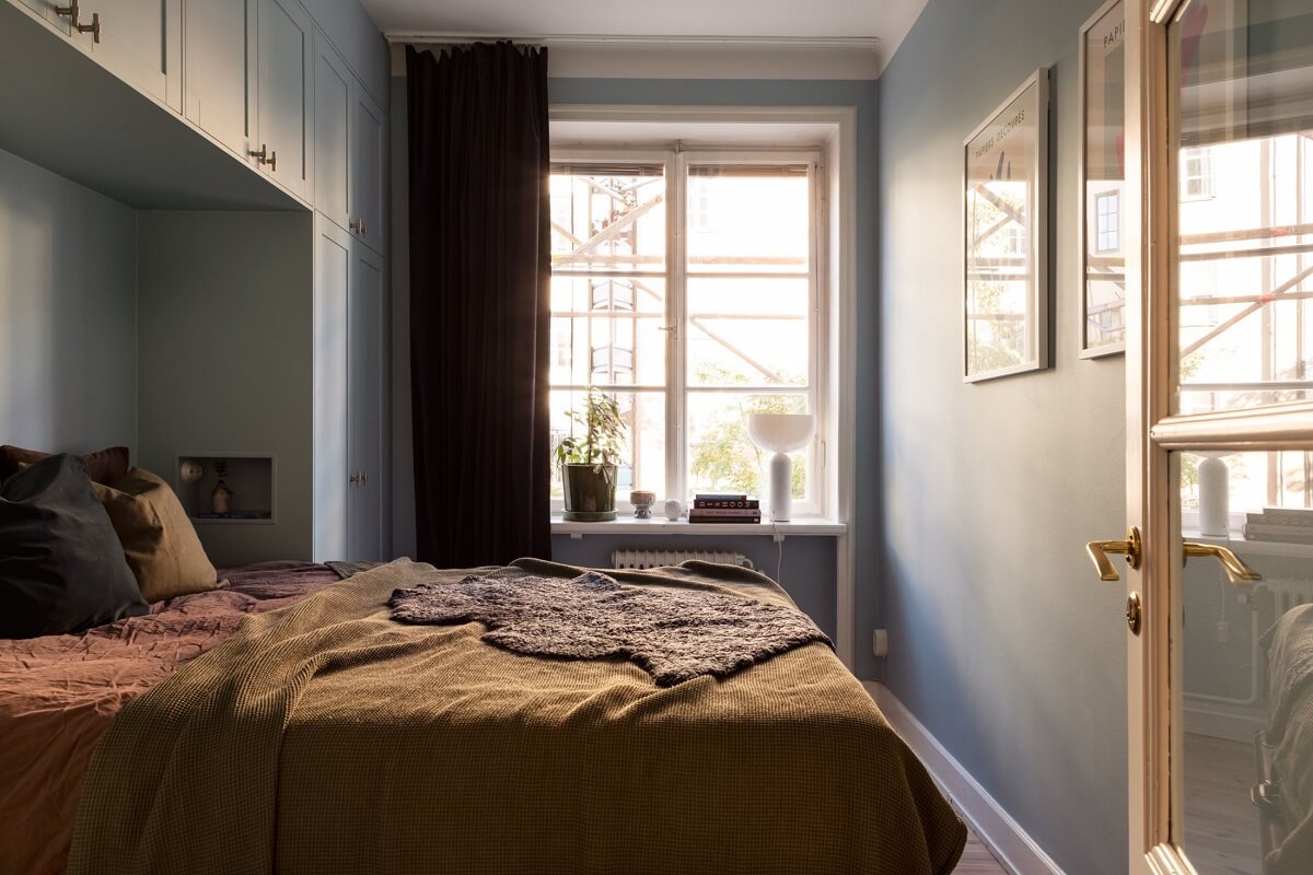 A Renovated Swedish Apartment with a Pink Bathroom 12 bedroom with custom wardrobes around the bed