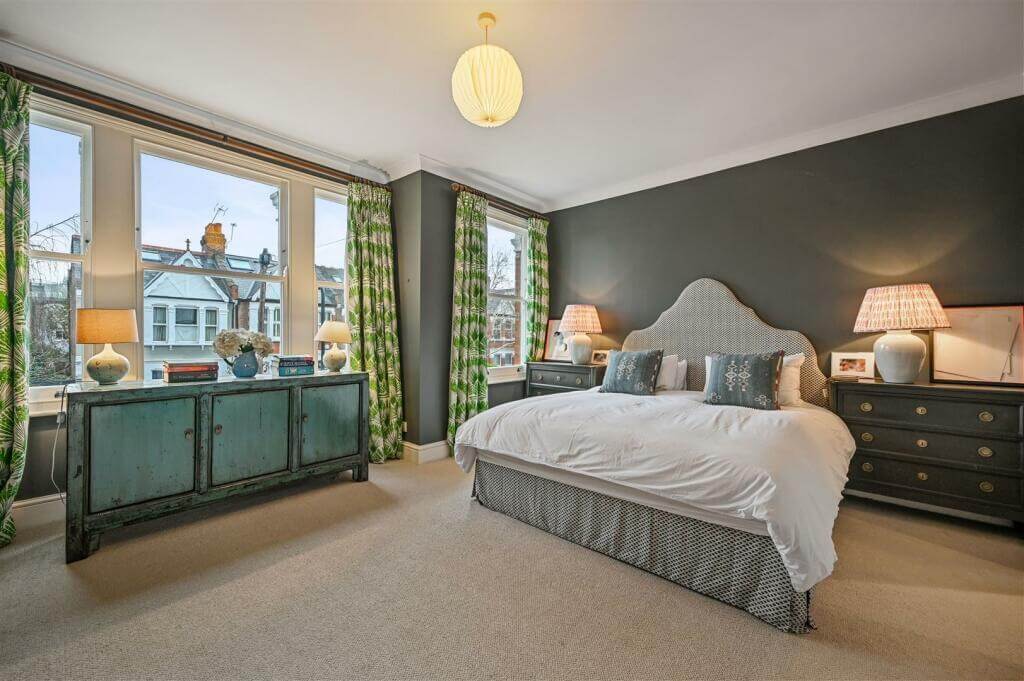 A London Family Home with Blue Color Accents 8 bedroom with dark gray walls