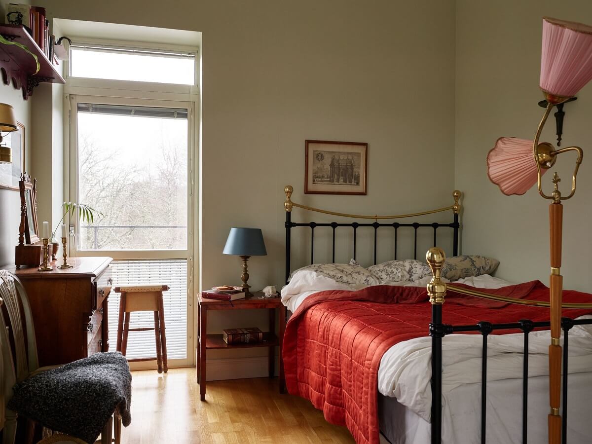 Floor-to-Ceiling Bookcases in a 1950s Swedish Home 13 bedroom with red throw