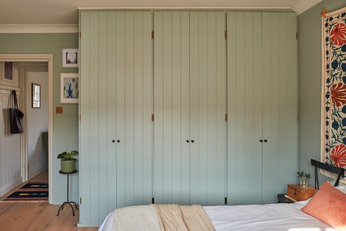 A Small Cottage-Style Apartment in London 16 bedroom with sage green walls and built in wardrobes