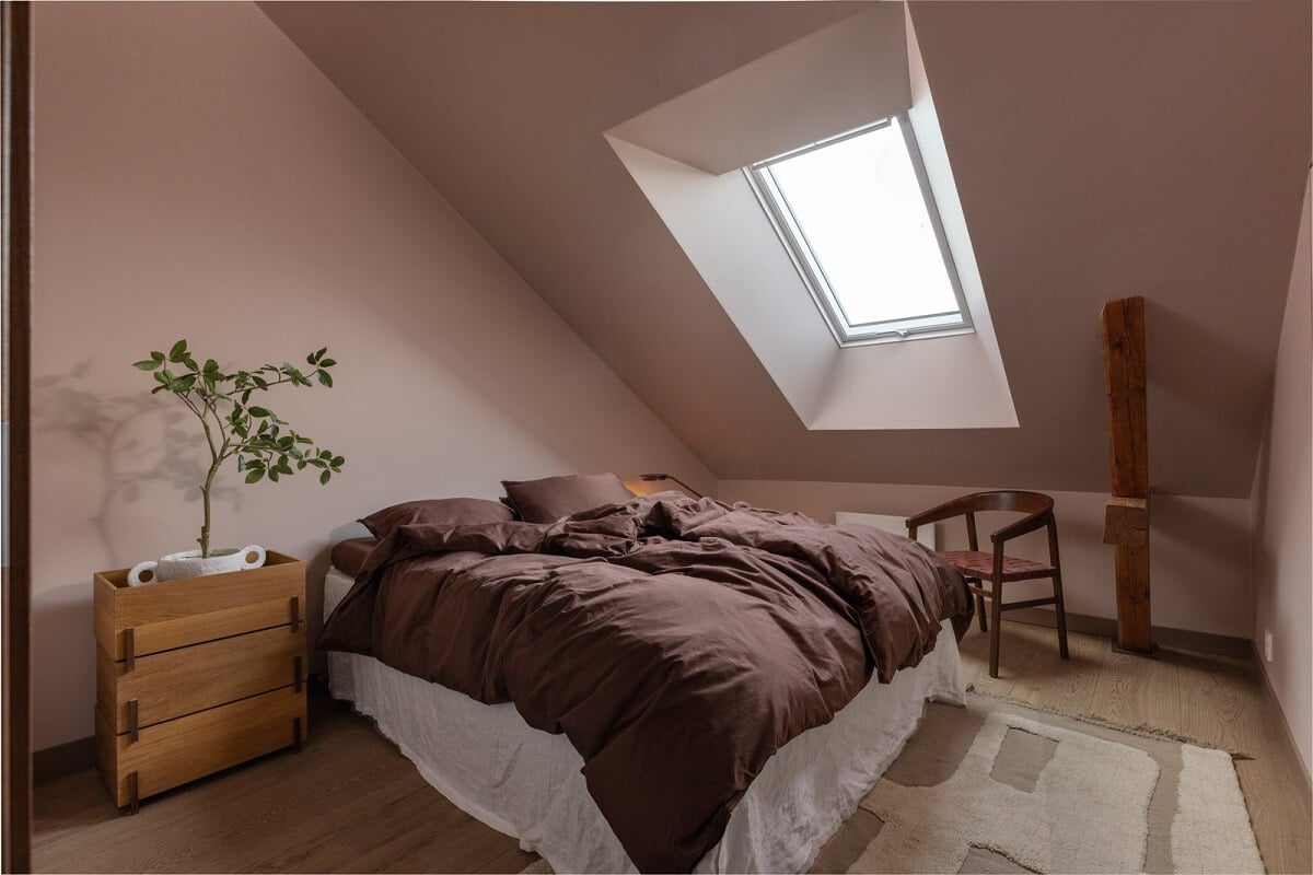 An Attic Apartment in Oslo with Exposed Wooden Beams 10 bedroom with slanted ceiling
