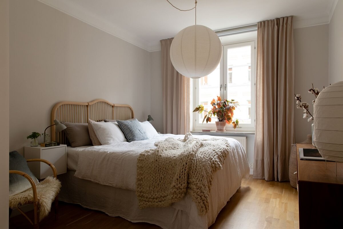 A Light Colored Swedish Apartment 9 bedroom with wicker headboard