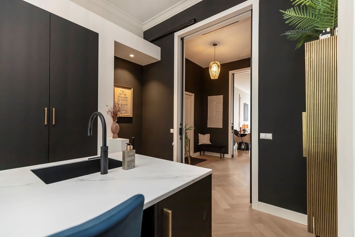 A Renovated Canal House with a Separate Pink Studio Apartment 8 black and white ktichen
