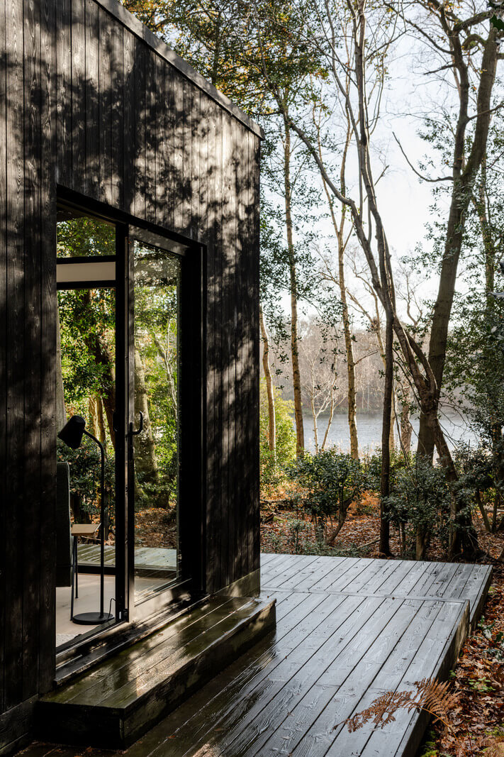 A Scandinavian-Inspired Cabin in the Woods 16 black cabin with lakeview
