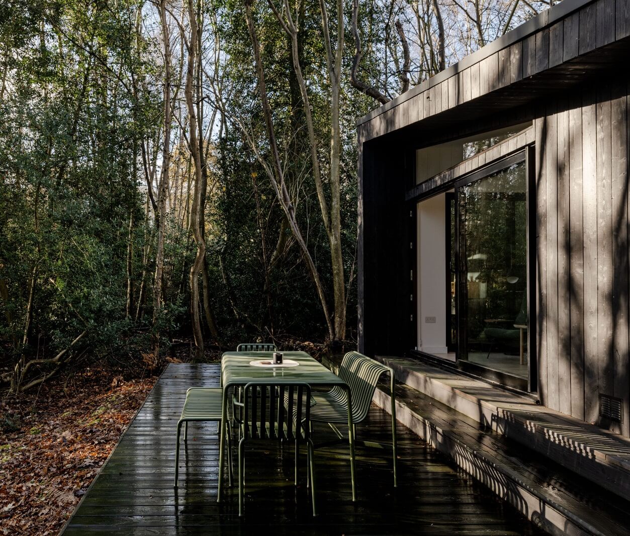 A Scandinavian-Inspired Cabin in the Woods 17 black cabin with wooden terrace